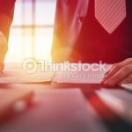 Close up businessman signing documents.